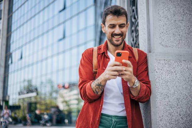 istock A relaxed man is walking down the street and using a smartphone. 2148958677