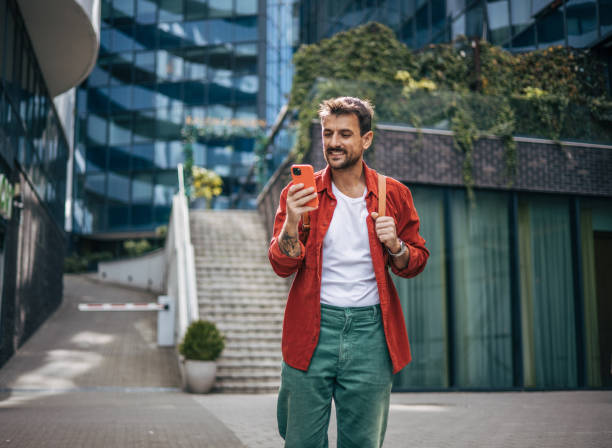 istock An attractive man is using a smartphone on the street. 2148958819