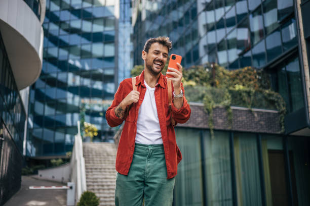 istock An attractive man is using a smartphone on the street. 2148958982