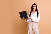 Portrait of stunning positive company founder use microsoft apple laptop empty space isolated on beige color background