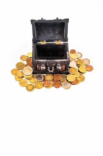 A small black box with gold coins on top of it