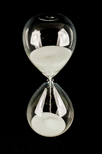 A glass hourglass with sand in it