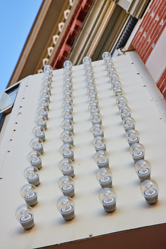 Daytime view of vertical light bulb pattern on Civic Theatre facade in downtown Muncie, Indiana - a unique display of urban design and architectural lighting.