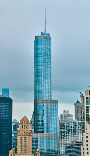 Modern Trump Tower skyscraper towering over historical architecture in Chicago, Illinois, captured from a high vantage point on a cloudy day in 2023.