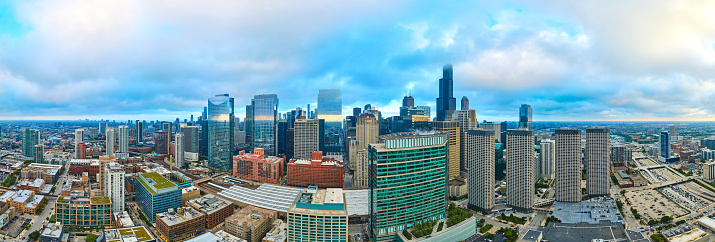 Aerial panorama of the 2023 Chicago skyline showing a bustling urban landscape with diverse skyscrapers under a gentle overcast light, captured using DJI Mavic 3 drone.