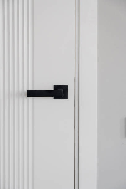 istock Modern black door handle on white wooden door in interior. 2148961950