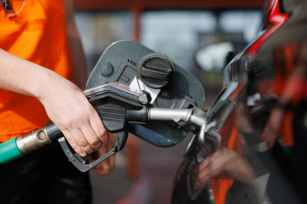 istock Hand holding petrol nozzle in tank and refueling 2148963172