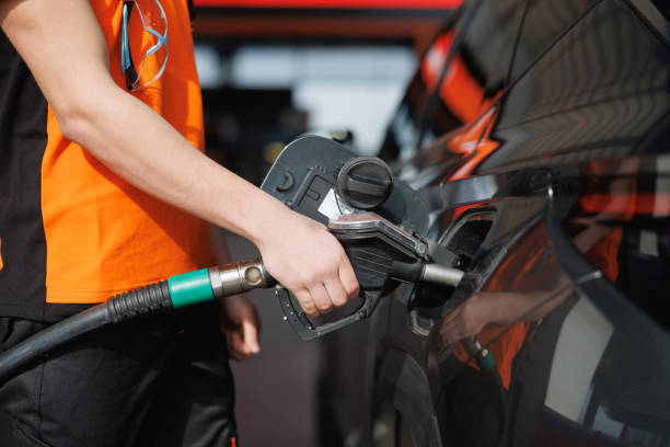 istock Holding petrol nozzle and refueling 2148963187