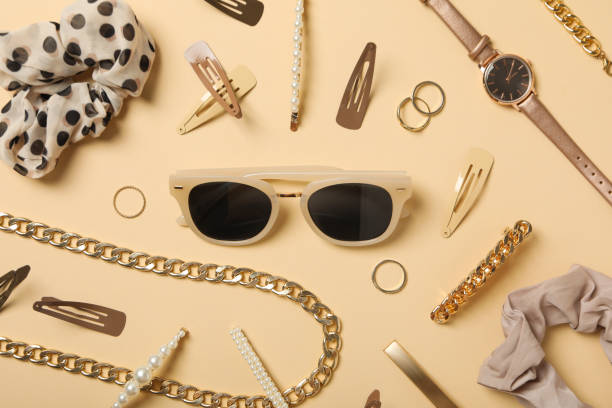 istock Beige sunglasses with feminine decorations around, on a beige background 2148963262