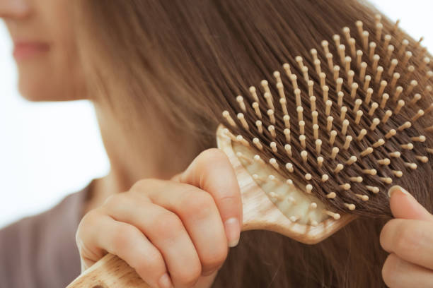istock Closeup on young woman combing hair 2148963412