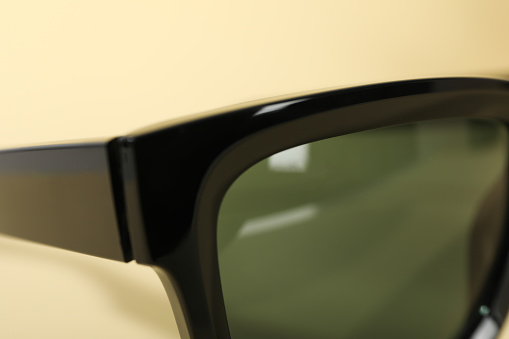 Close-up view of dark sunglasses on a light background
