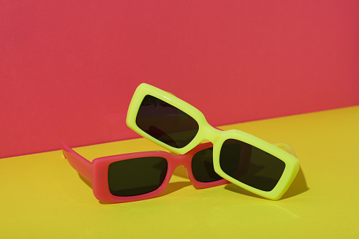 Red and yellow sunglasses on red and yellow background