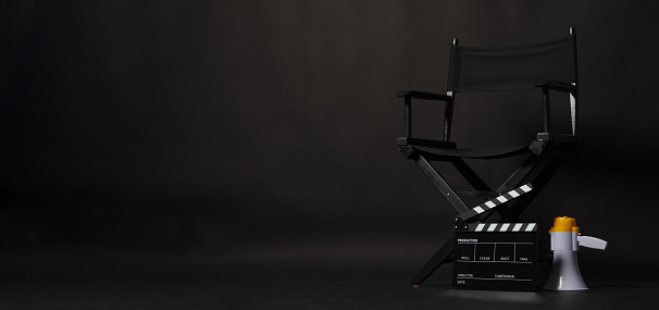 Black director chair and Clapper board  with megaphone on black background