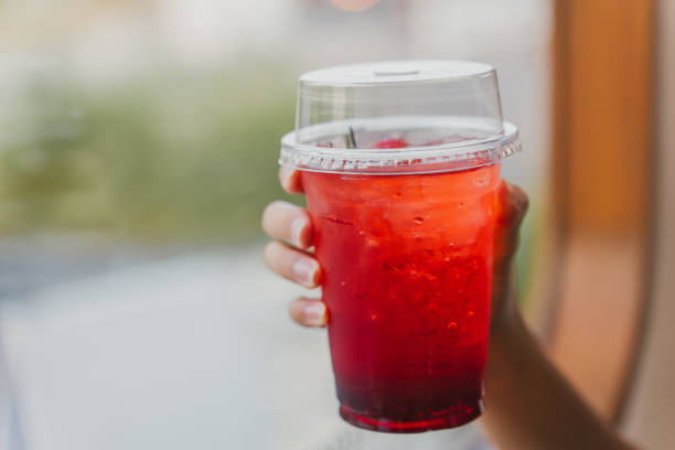 istock A woman's hand is holding a strawberry soda. 2148964155