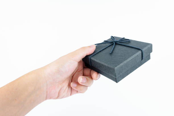 istock Hand holding black gift box on white background. 2148964637