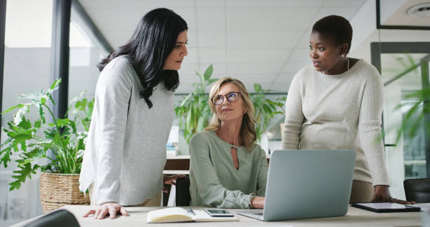istock Professional people, planning and teamwork on computer for strategy meeting, collaboration and corporate communication in office. Business women, manager and employees on laptop for company ideas 2148964942