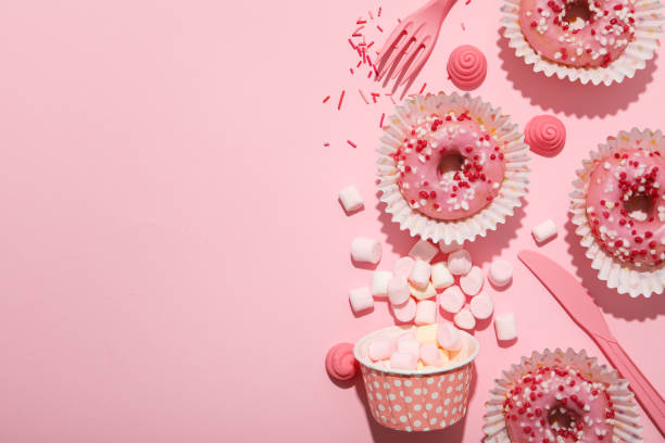 istock Donuts, jelly candies and marshmallows on pink background, space for text 2148965139