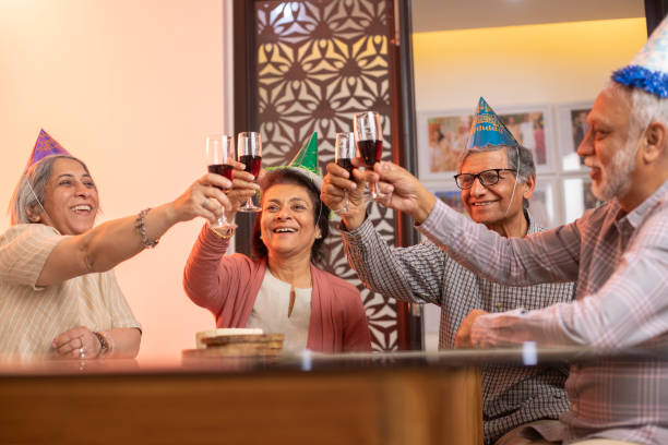 istock Old friends toasting drinks at social gathering party 2148965692