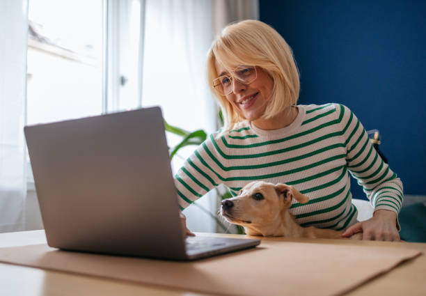 istock Woman Working From Home While Being Distracted by Her Puppy 2148966280