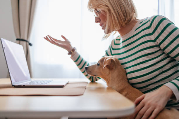 istock Woman Working From Home While Being Distracted by Her Puppy 2148966295