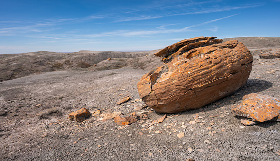 Large round red concretion on the horizon at Red Rock Coulee near Seven Persons, Alberta, Canada