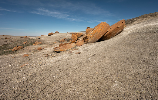 Large round broken red concretion on a hillside at Red Rock Coulee near Seven Persons, Alberta, Canada