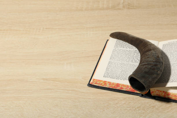 istock Book and horn on light wooden background, space for text 2148968602
