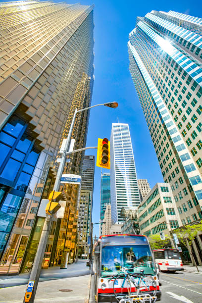 Looking up view of Toronto financial buildings on Bay Street with Toronto transit bus