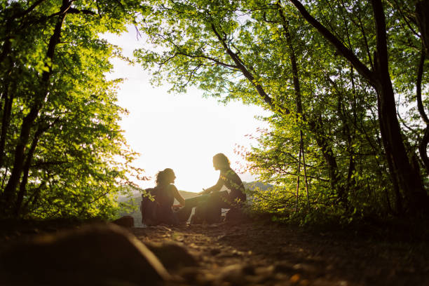 Two women taking a break from hiking to admire the view
