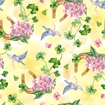Horseshoe and clover seamless pattern on watercolor backdrop. Painted flowers and bird aquarelle. Lucky symbol, four leaves clover hand drawn. St. Patrick day decoration, springtime textile, paper.