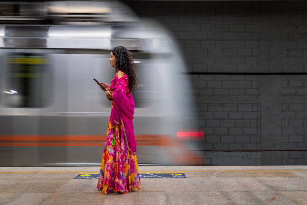 istock Indian girl using a mobile phone at metro station, India 2148971981