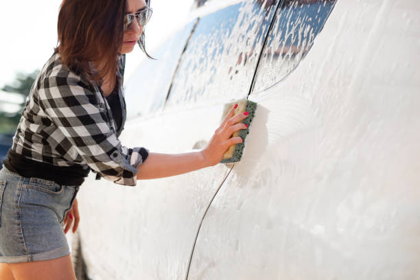 istock Girl's hand with sponge cleaning car 2148972016
