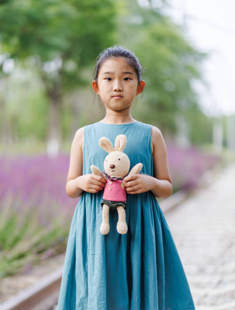 Little girl holding rabbit toy
