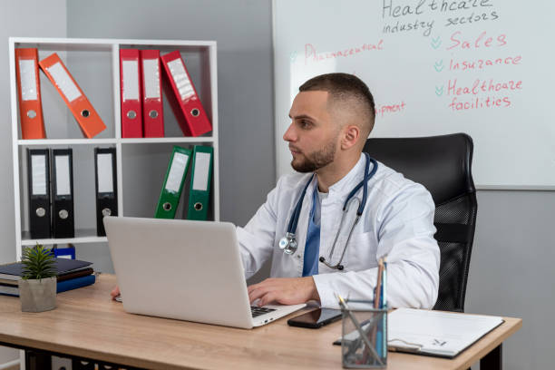 doctor man sitting at the desk using laptop computer for webinar training ar medical themes