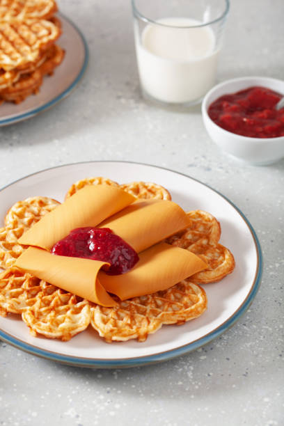 istock waffles with Norwegian brunost traditional brown cheese and raspberry jam 2148974155
