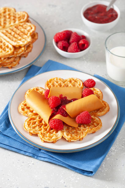 istock waffles with Norwegian brunost traditional brown cheese and raspberry jam 2148974230