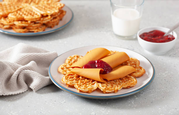 istock waffles with Norwegian brunost traditional brown cheese and raspberry jam 2148974293