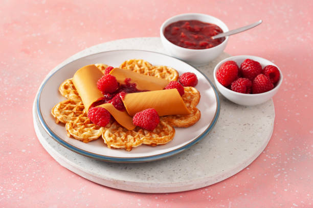 istock waffles with Norwegian brunost traditional brown cheese and raspberry jam 2148974320