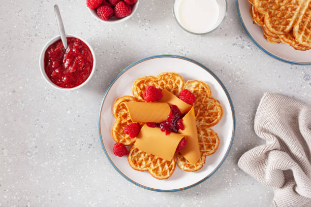 istock waffles with Norwegian brunost traditional brown cheese and raspberry jam 2148974334