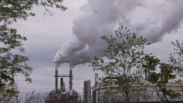 Air pollution in big cities. Refinery plant in New Jersey is in full operation, with steam billowing out from its pipes