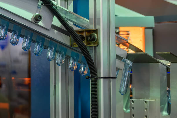 istock Conveyor belt deliver the preform shape to the  blow mold machine. 2148975399