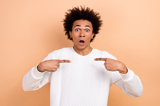 Photo of shocked astonished man wear trendy clothes arms indicating himself wow open mouth isolated on beige color background.