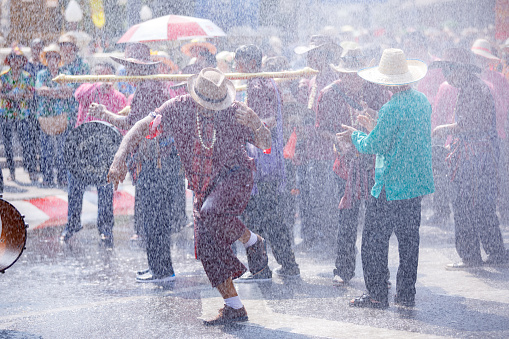 ChiangMai , Thailand - APR 16 2024 : Songkran festival (Thailand new year)  have fun splashing water around street on an annual basis In Chiang Mai Thailand.