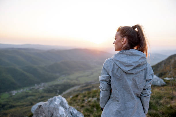 istock Woman Enjoying Sunset on Mountain Top 2148977159