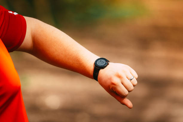istock Jogger looking at smart watch on forest trail 2148977292