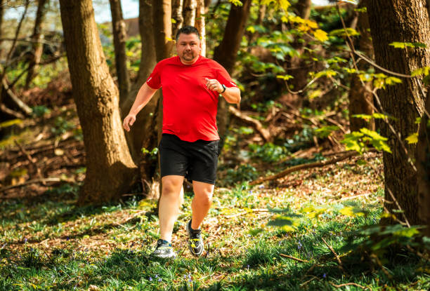 istock Mid adult man trail running in forest 2148977301