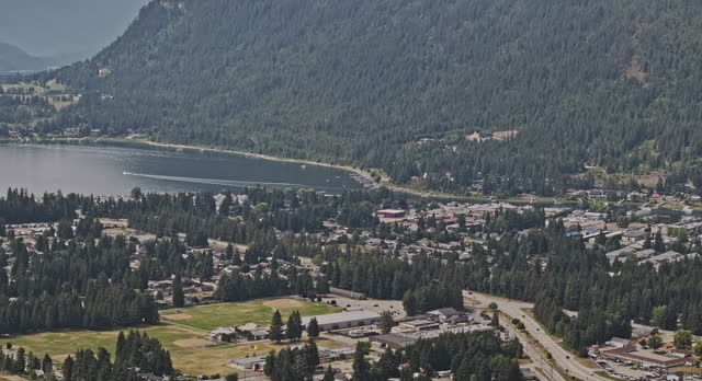 Sicamous BC Canada Aerial v2 zoomed view drone flyover town center capturing forested mountains and pristine waters of Shuswap Lake and Mara Lake - Shot with Mavic 3 Pro Cine - July 2023