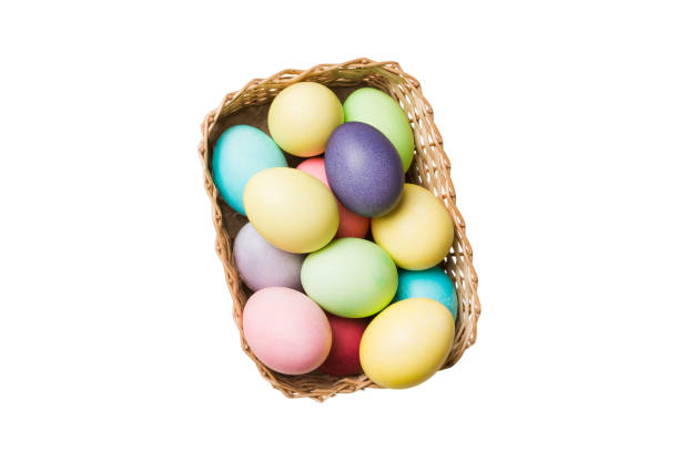 istock Basket of colorful Easter eggs isolated on white background. Easter basket filled with colored eggs top view holiday concept 2148977817