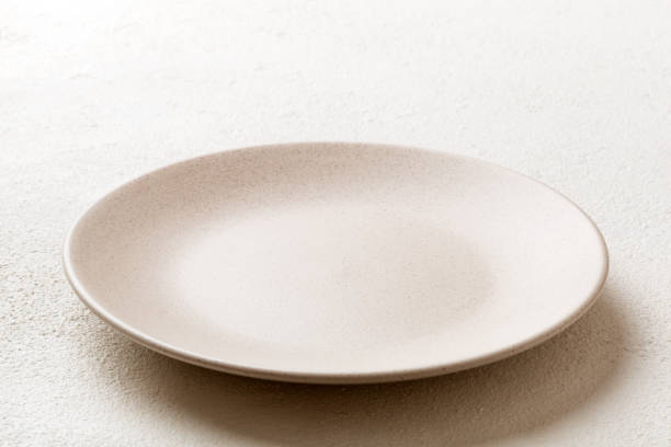 istock Perspective view of empty light plate on cement background. Empty space for your design 2148977819