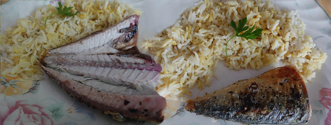 Browned mackerel served with saffron rice